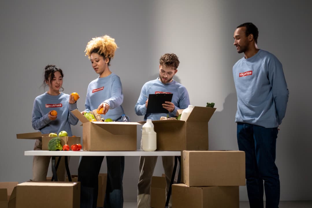 Volunteers in moving truck with donation boxes